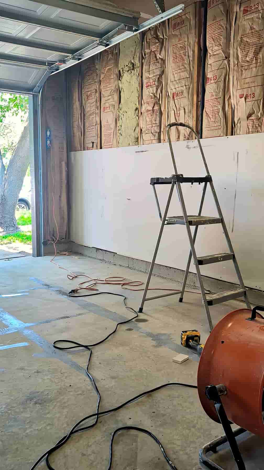 Drywall being hung in an unfinished San Diego garage