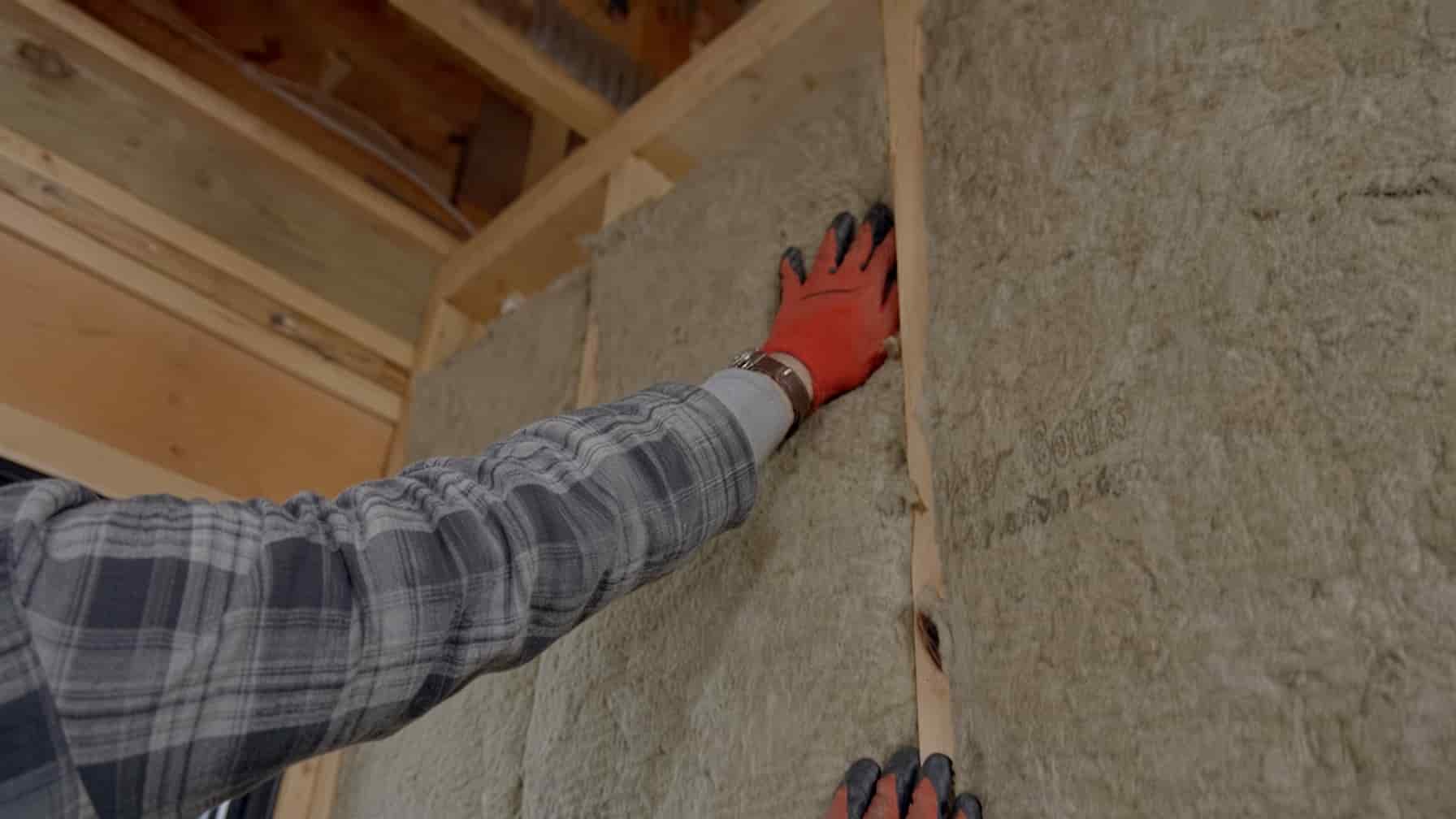 Sound-rated drywall assembly being installed on a shared wall in San Diego